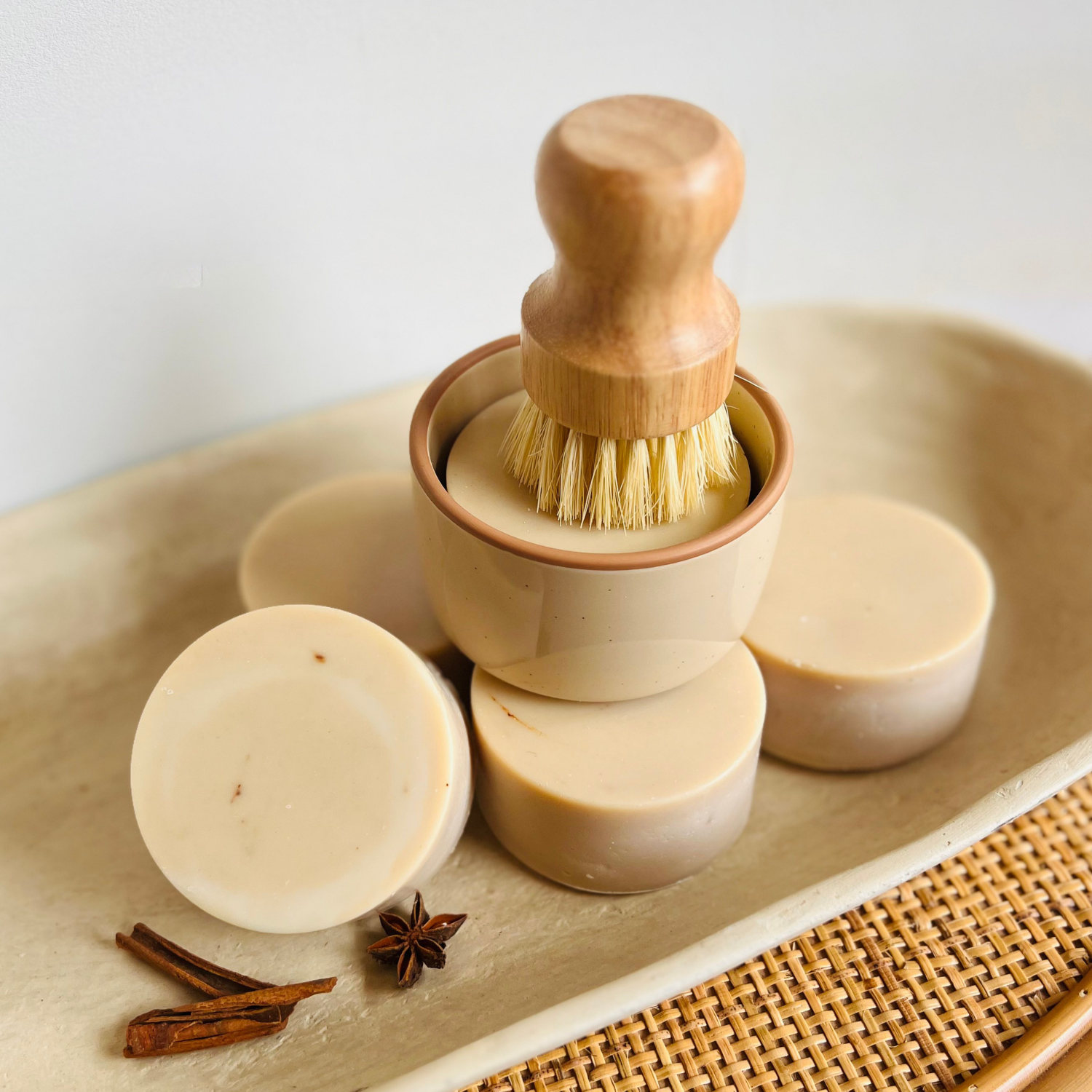 Wooden dish brush resting in ceramic ramekin next to fall dish soap refill bars